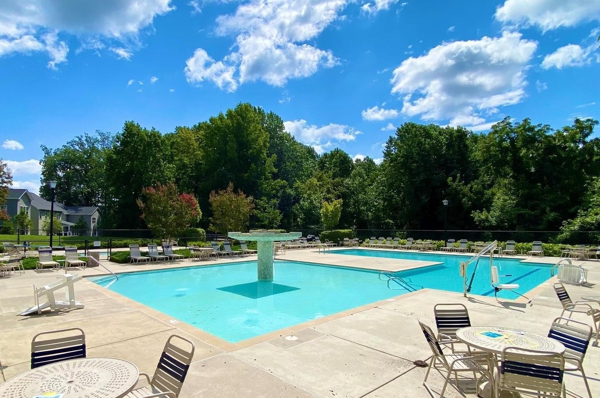 The community pool with its fountain and lounge chairs